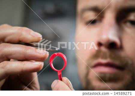 Jeweler working with wax model ring Jeweler working with wax model ring 14589271