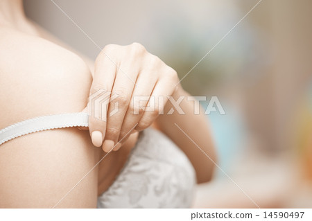 Woman undressing brassiere 14590497