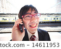 A businessman who makes a phone call with a smile 14611953