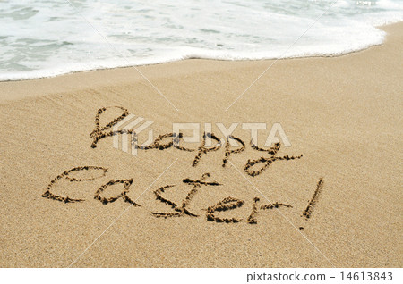happy easter written in the sand of a beach 14613843