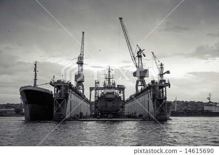 Floating dry dock with ship under repair inside 14615690