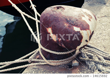 Old rusted mooring bollard with naval ropes 14615692