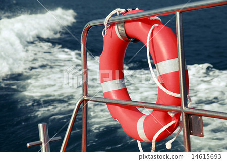 Red lifebuoy hanging on railings of rescue boat 14615693