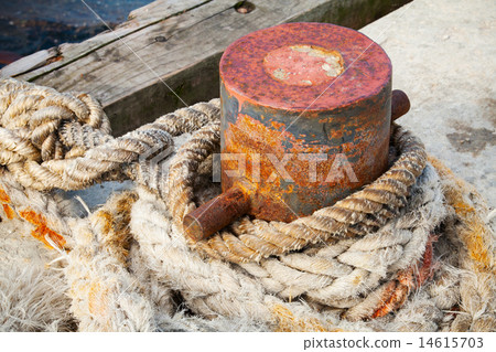 Old rusted mooring bollard with naval ropes 14615703