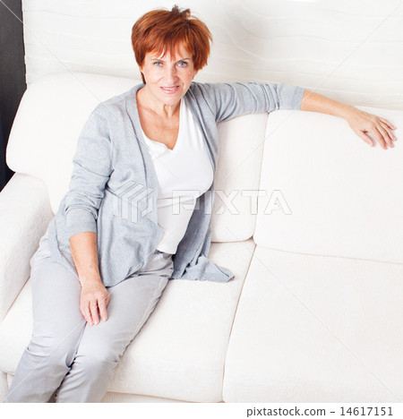 Happy mature woman on sofa Happy mature woman on sofa 14617151