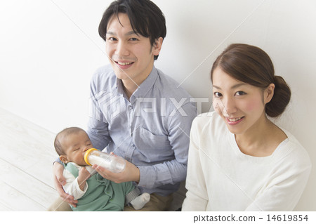 A couple letting children drink milk A couple letting children drink milk 14619854