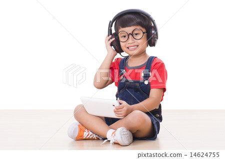 Happy boy with headphones connected to a tablet Happy boy with headphones connected to a tablet 14624755