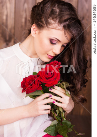 Pretty teenager girl holding bouquet of red roses 14634689