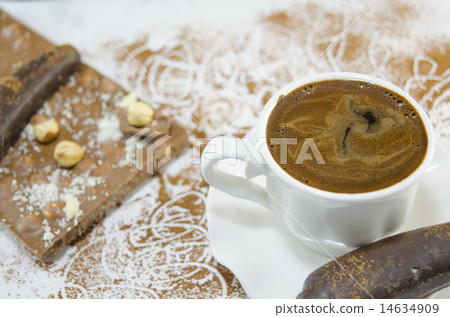 White cup of coffee and a chocolate 14634909