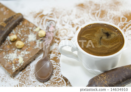 White cup of coffee and a chocolate  14634910