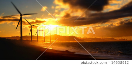 Stock Photo: Wind turbine power silhouettes at ocean coastline