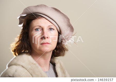 Serious brunette in taupe hat and fur Serious brunette in taupe hat and fur 14639157