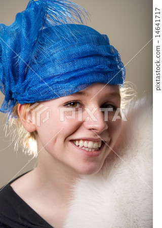 Smiling redhead in blue hat and fur Smiling redhead in blue hat and fur 14641717
