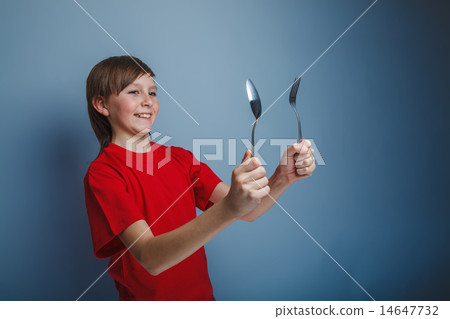 boy teenager European appearance in a red shirt holding a Dark B 14647732