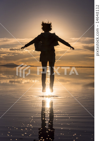 Women in Uyuni salt lake evening view of Mirror Lake Women in Uyuni salt lake evening view of Mirror Lake 14648112