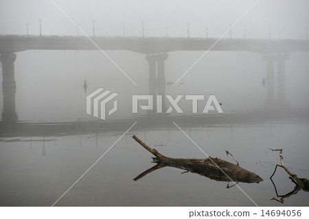Bridge through river in misty morning Bridge through river in misty morning 14694056
