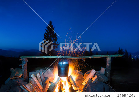 Cooking food in the pot on fire 14694243