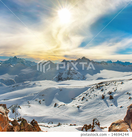 Snowy blue mountains in clouds 14694244