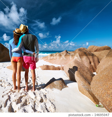 Couple at tropical beach wearing rash guard 14695047
