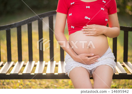 Image of pregnant woman touching her belly with hands Image of pregnant woman touching her belly with hands 14695942