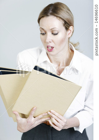 Business woman juggling folders Business woman juggling folders 14696610