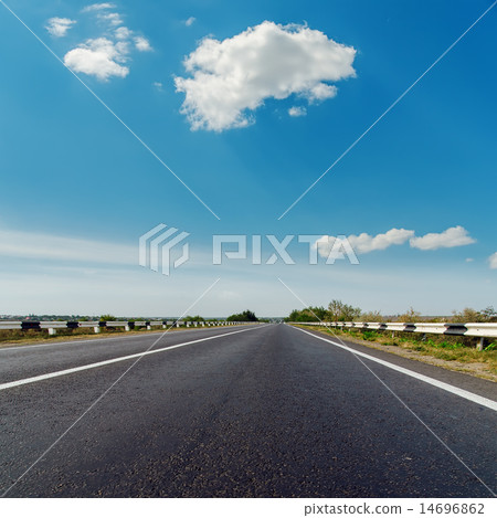 asphalt road to horizon under blue cloudy sky asphalt road to horizon under blue cloudy sky 14696862