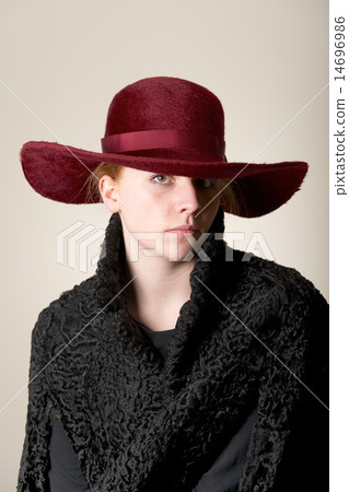 Redhead serious in maroon hat and black coat Redhead serious in maroon hat and black coat 14696986