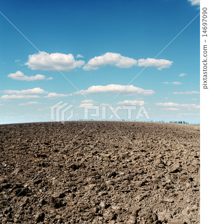 plowed field and cloudy sky 14697090