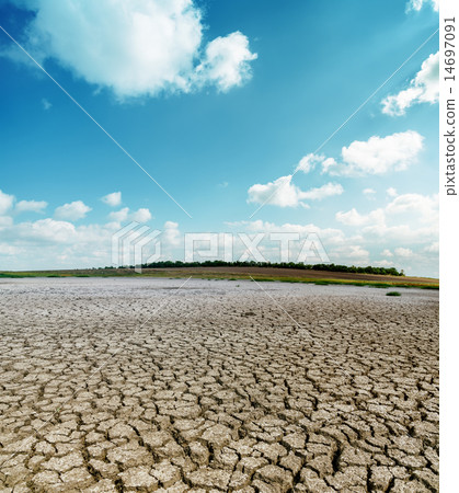 cracked desert and clouds in sky 14697091