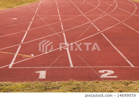 White track number on red rubber outdoor racetrack White track number on red rubber outdoor racetrack 14699059