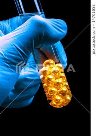 Hand holding tube with white pearls Hand holding tube with white pearls 14701658