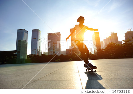 woman skateboarder legs skateboarding at sunrise c woman skateboarder legs skateboarding at sunrise c 14703118
