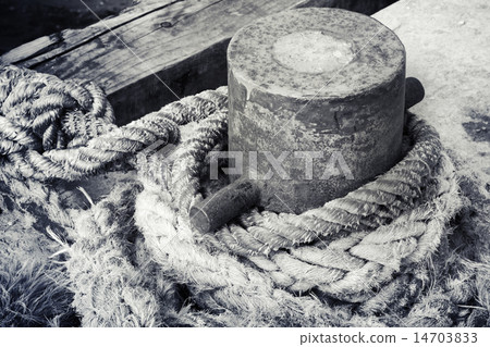 Old rusted mooring bollard with naval ropes 14703833