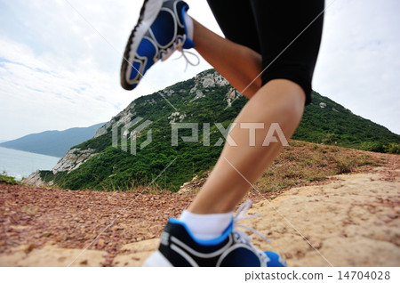 young woman hiker legs running on seaside mountain young woman hiker legs running on seaside mountain 14704028