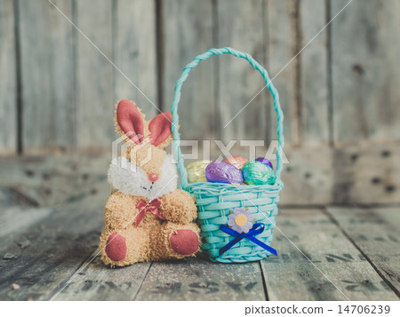 chocolate easter eggs in a basket and rabbit doll chocolate easter eggs in a basket and rabbit doll 14706239