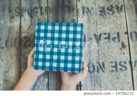 Blue box in child hand. 14706272