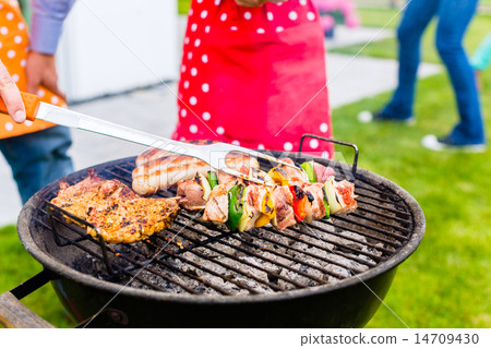 Family barbecue together in garden home Family barbecue together in garden home 14709430