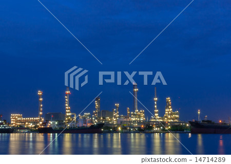 Oil refinery beside a river during twilight 14714289