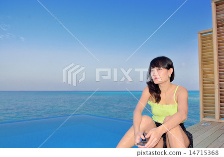 The sea at dusk and a young lady 14715368