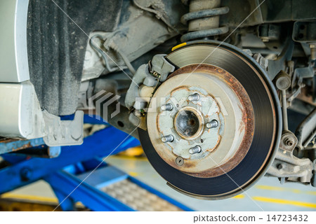 Close up of disk brake on car in process Close up of disk brake on car in process 14723432