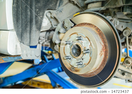 Close up of disk brake on car in process Close up of disk brake on car in process 14723437