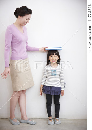 A girl measuring his back A girl measuring his back 14728848
