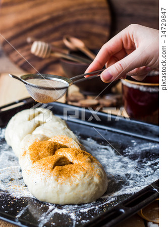 Butter raw dough sprinkled with cinnamon Butter raw dough sprinkled with cinnamon 14729847