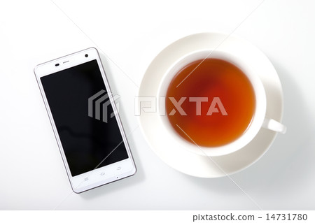 White smartphone and a cup of tea on white table 14731780