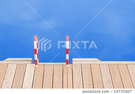 Wooden pier and ladder by the blue water. 14735007