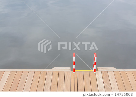 Wooden pier and ladder by the water. 14735008