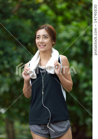 Young Chinese listening to music while exercising 14740830