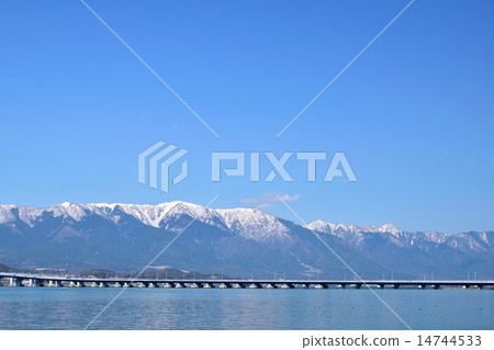 The Lake Biwa Ohashi bridge passing through Biwa lake in early spring and Higarashi Mountain of snow as the background 14744533
