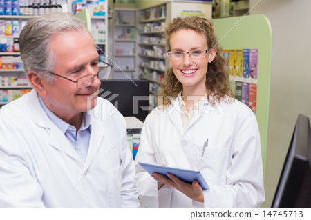 Team of pharmacists using laptop pc 14745713