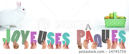 Composite image of hands holding up joyeuses pasques 14745759